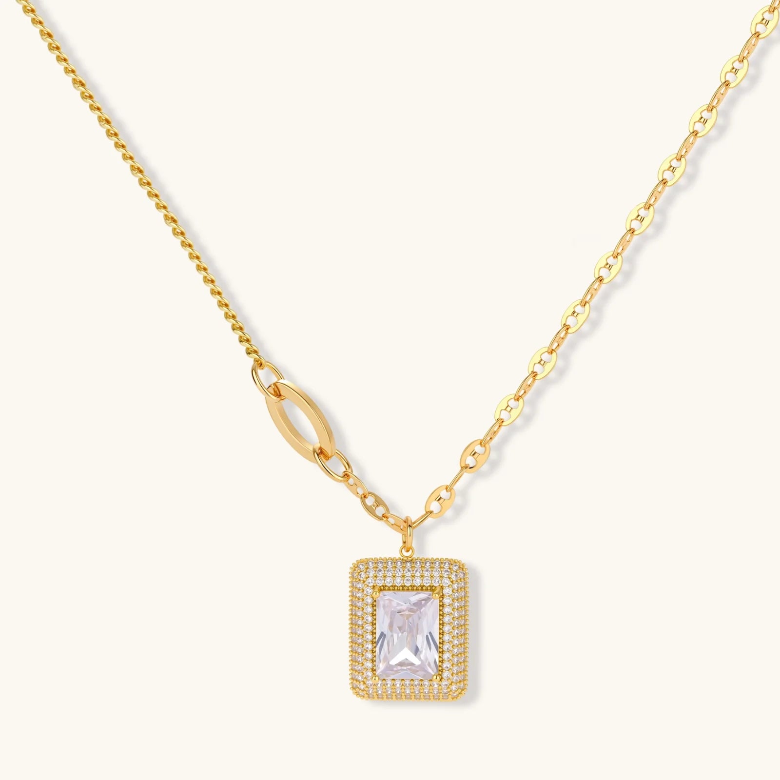 Gold-plated jewelry set with rectangular cubic zirconia stones in pave halo settings on cream background