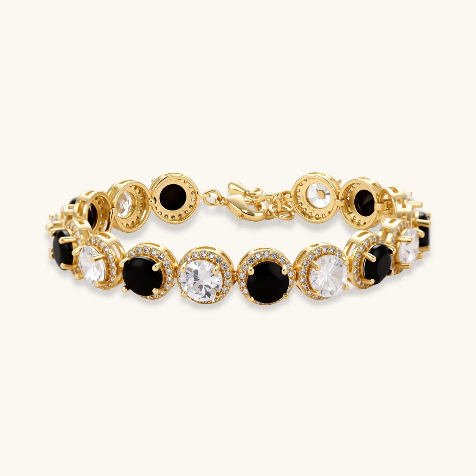 Gold-plated jewelry set with alternating black and clear cubic zirconia stones, featuring necklace, earrings and bracelet