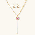 Gold-plated circular medallion necklace set with white enamel base and pink cubic zirconia accent stones