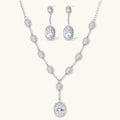 Elegant white gold plated jewelry set with oval cubic zirconia stones in halo settings, featuring Y-necklace and drop earrings.