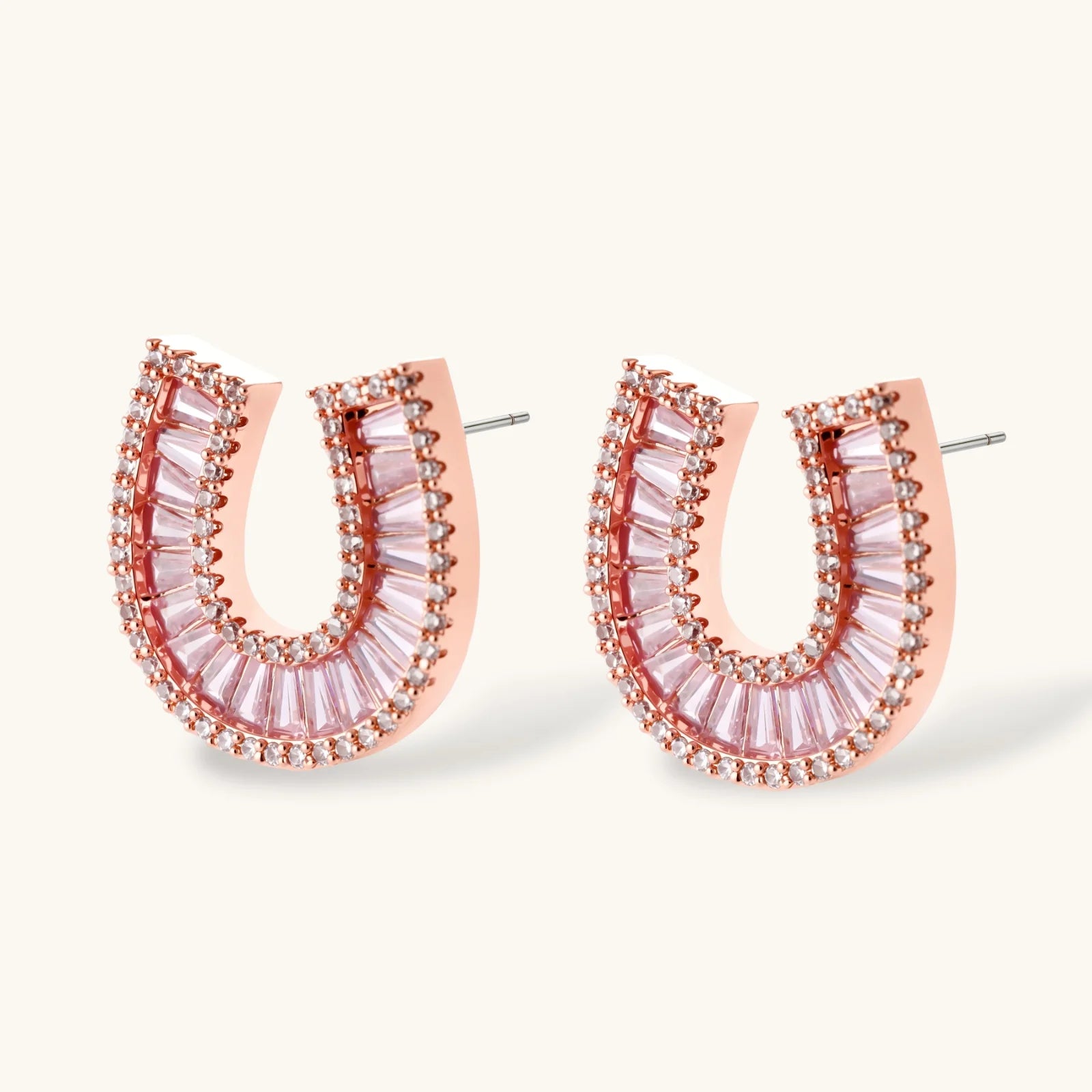 Sparkling horseshoe-shaped jewelry set with AAA cubic zirconia in gold-plated and white gold finishes on cream background.