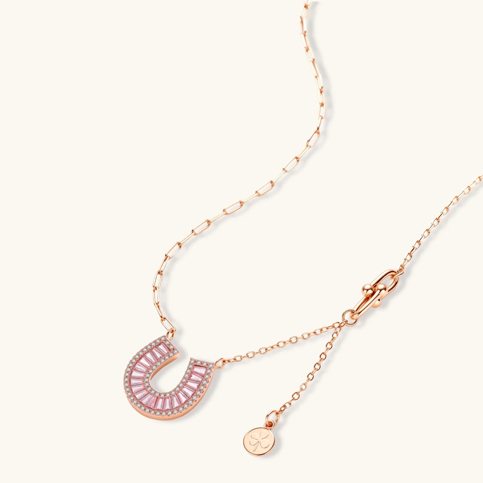 Sparkling horseshoe-shaped jewelry set with AAA cubic zirconia in gold-plated and white gold finishes on cream background.