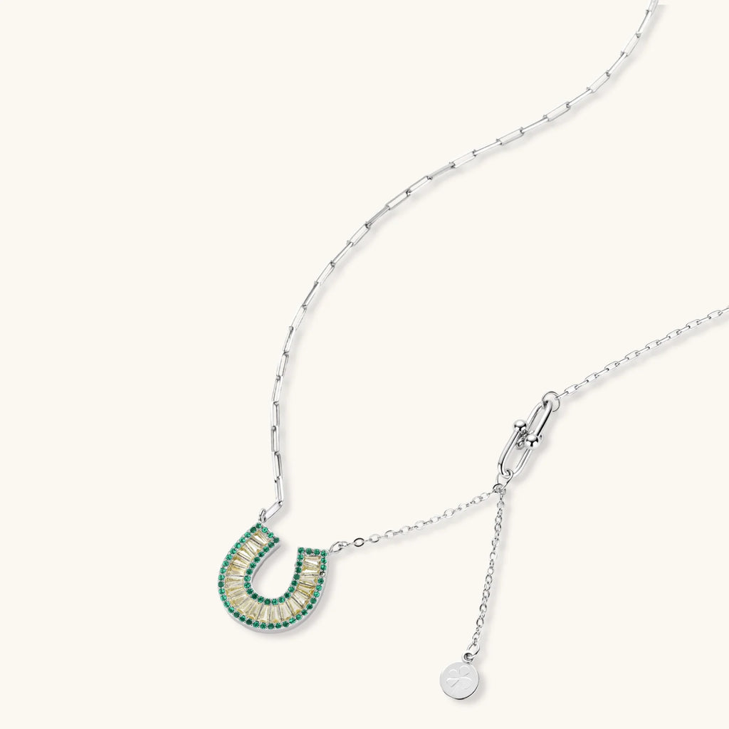 Sparkling horseshoe-shaped jewelry set with AAA cubic zirconia in gold-plated and white gold finishes on cream background.