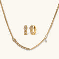 Gold-plated necklace with geometric diamond segments and matching huggie earrings featuring cubic zirconia details