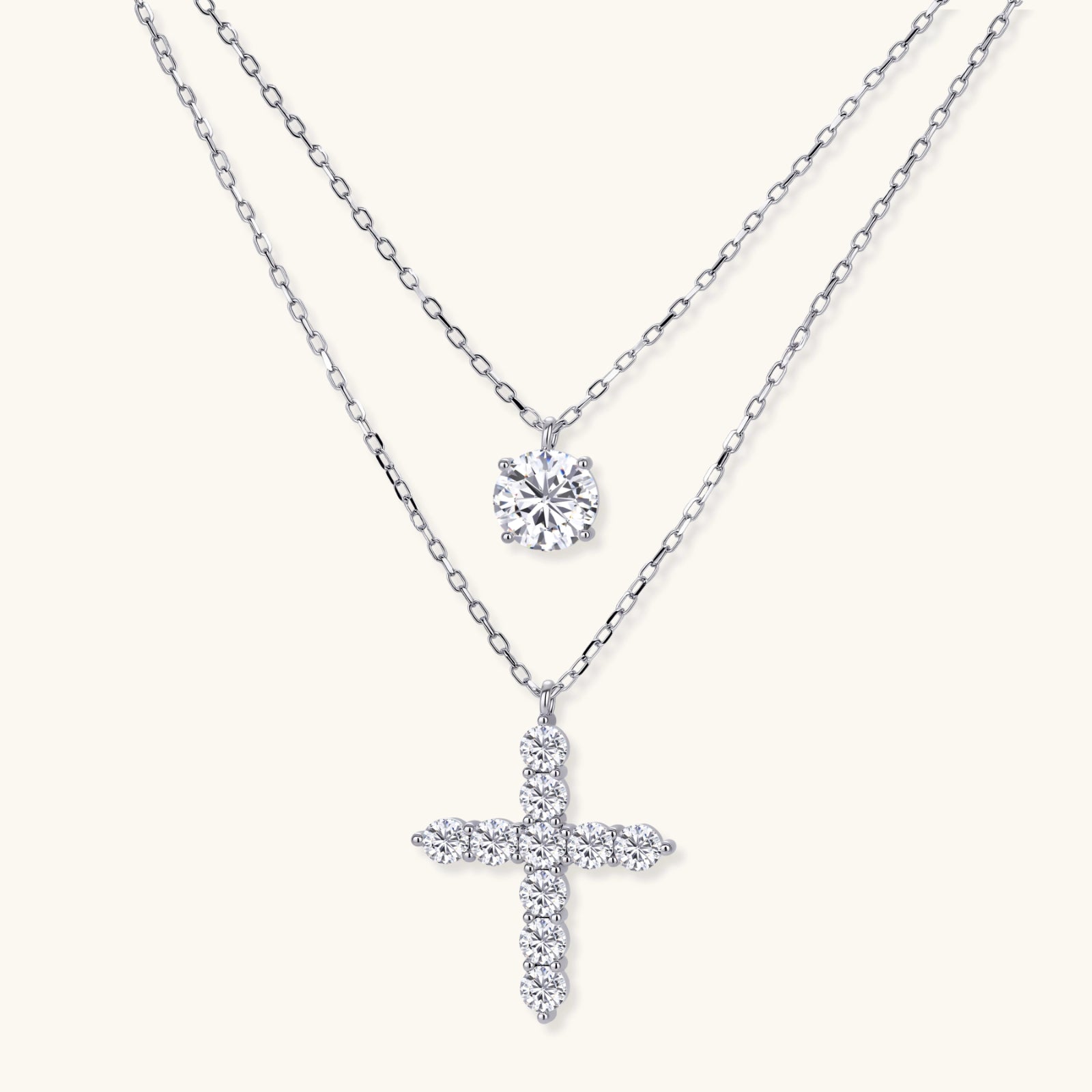 Two delicate sterling silver necklaces with moissanite stones - one solitaire pendant and one cross pendant on white background.