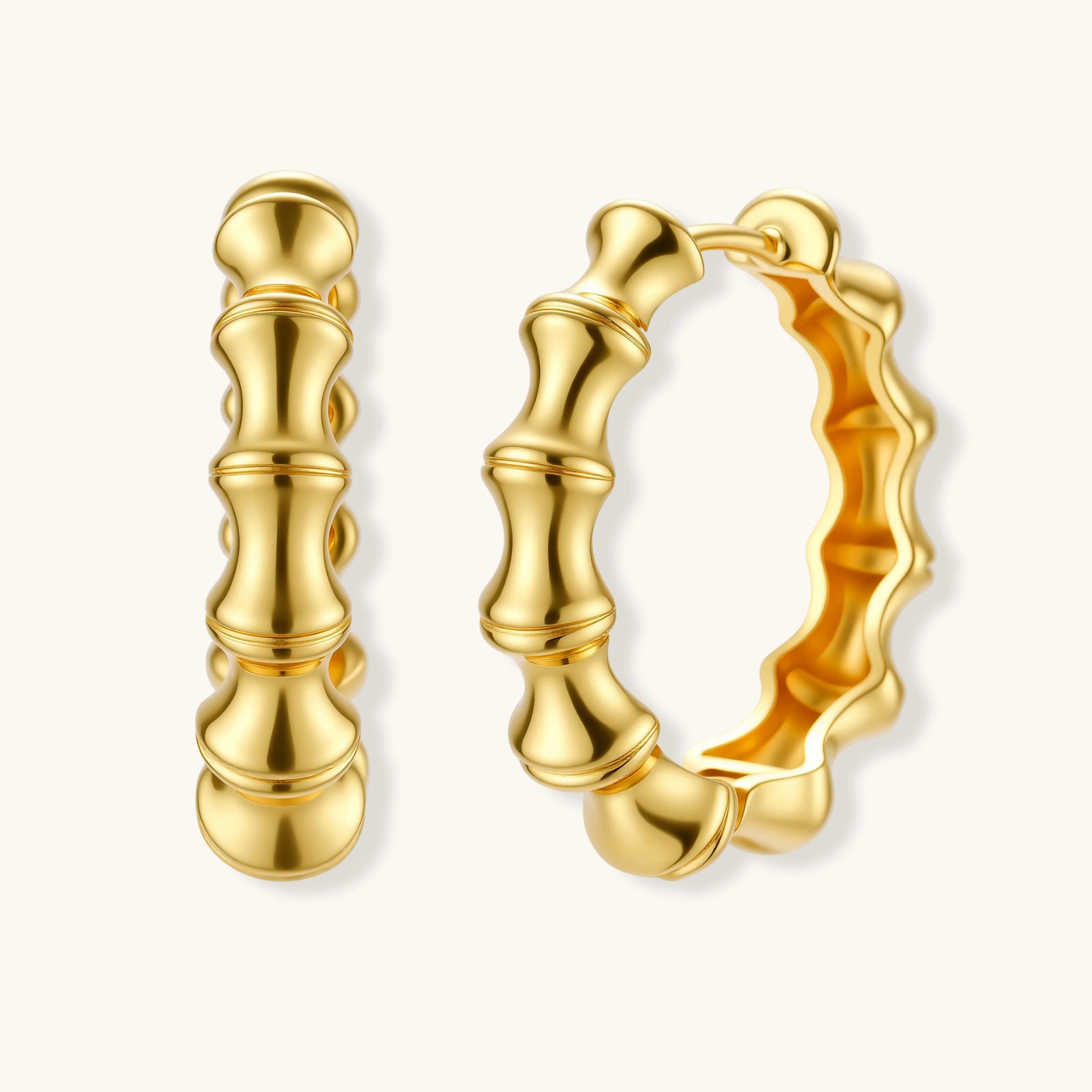 Close-up of gold-plated sterling silver hoop earrings with bamboo-inspired segmented design on white background.