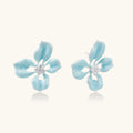Turquoise enamel flower stud earrings with marbled finish and crystal centers on 18K gold plated brass