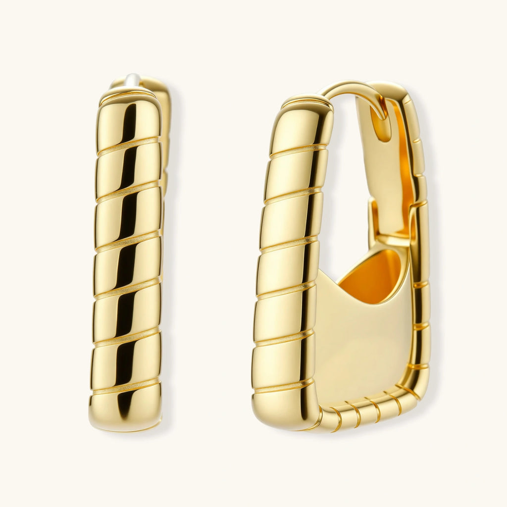 Chunky segmented gold-plated huggie hoop earrings with bamboo-inspired geometric design on white background.