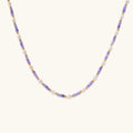 Delicate 18K gold vermeil necklace with alternating lavender zirconia beads and white freshwater pearls on cream background