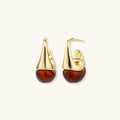Modern drop earrings with curved gold-plated copper tops and amber resin bottoms creating an organic teardrop silhouette.