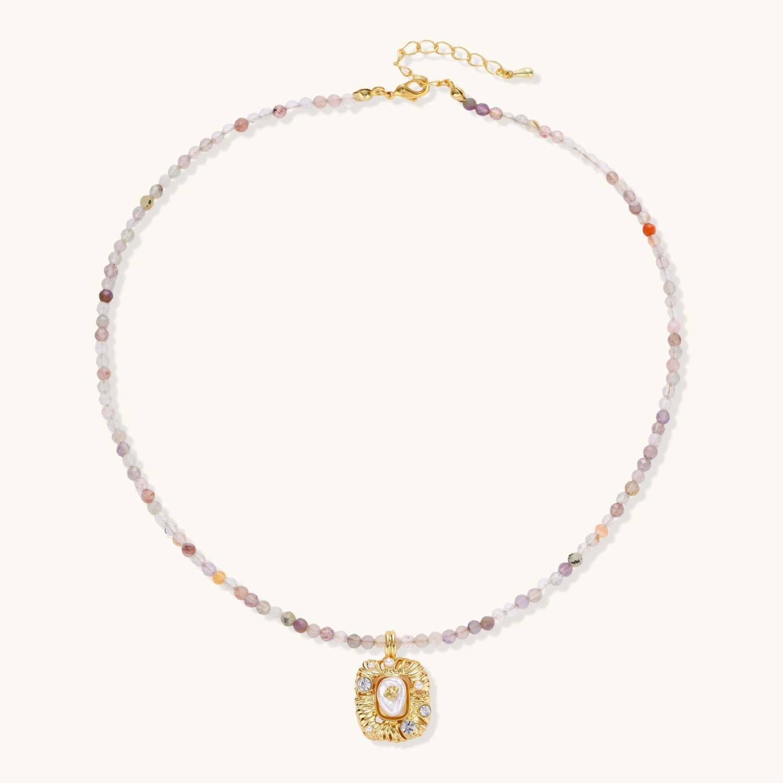 Ornate gold-plated pendant necklace with multicolored gemstone beads in purple, pink and clear tones on white background